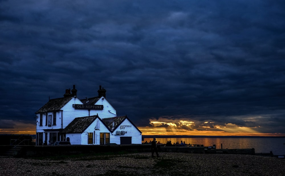  a house with a chimney by the lake