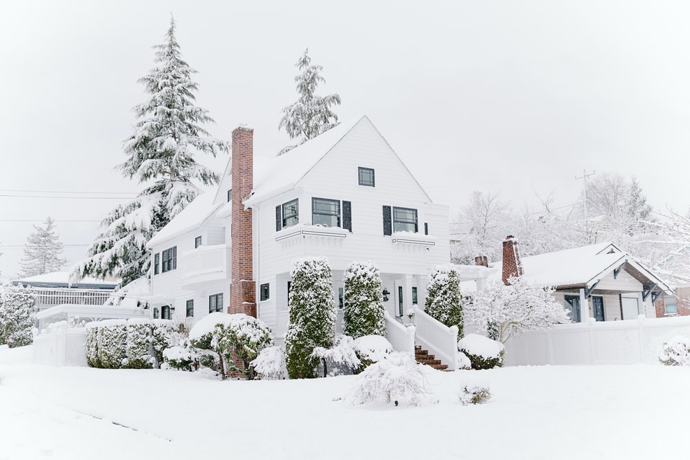 a chimney house covered in snow