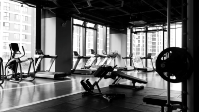 An empty gym with a fully-equipped floor, including treadmills and more.